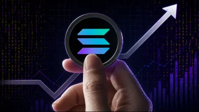 A hand holding a physical Solana (SOL) coin in front of a glowing upward-trending arrow and a purple digital binary code price chart background.