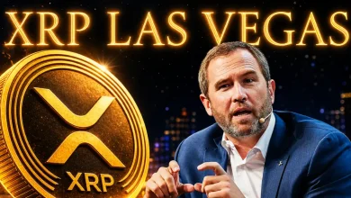 Ripple CEO Brad Garlinghouse speaking next to a large golden XRP coin with glowing "XRP LAS VEGAS" text in the background.