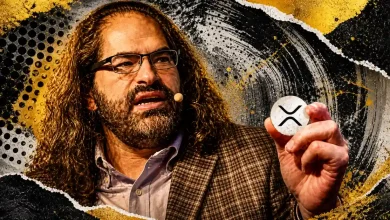 A portrait of Ripple CTO David Schwartz holding a small silver XRP coin against a gritty, textured background of black, gold, and white brushstrokes.