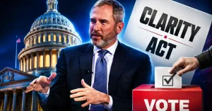 Brad Garlinghouse speaking in front of the U.S. Capitol building, positioned next to a "Clarity Act" sign and a red ballot box with a hand casting a vote.