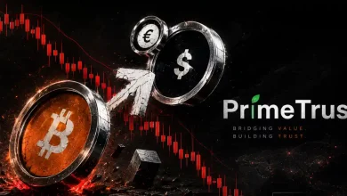 A cracked, fragmented golden Bitcoin token split down the middle on a dark red background with sharp descending market candlestick chart patterns.