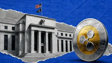 A prominent silver XRP token coin resting alongside a green shield icon displaying a checkmark, set against a dark background with silhouettes of government buildings.