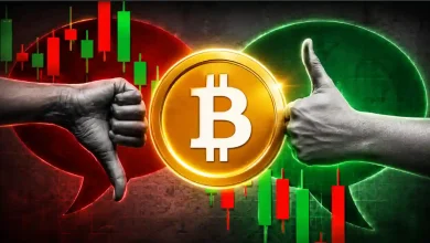 A fractured, cracked golden Bitcoin token coin split down the middle against a dark red backdrop with sharp descending market candlestick chart lines.