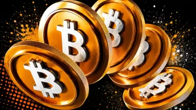 A row of five large golden Bitcoin coins with silver logos falling against a dark background with orange paint splatters.