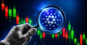 A hand holding a magnifying glass over a blue Cardano ADA token against a dark candlestick chart background.