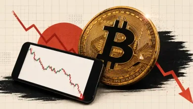 A smartphone showing a plunging candlestick chart next to a large gold Bitcoin coin with a downward red arrow background.