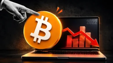 A gold Bitcoin token in front of a steep downward-trending red market graph.