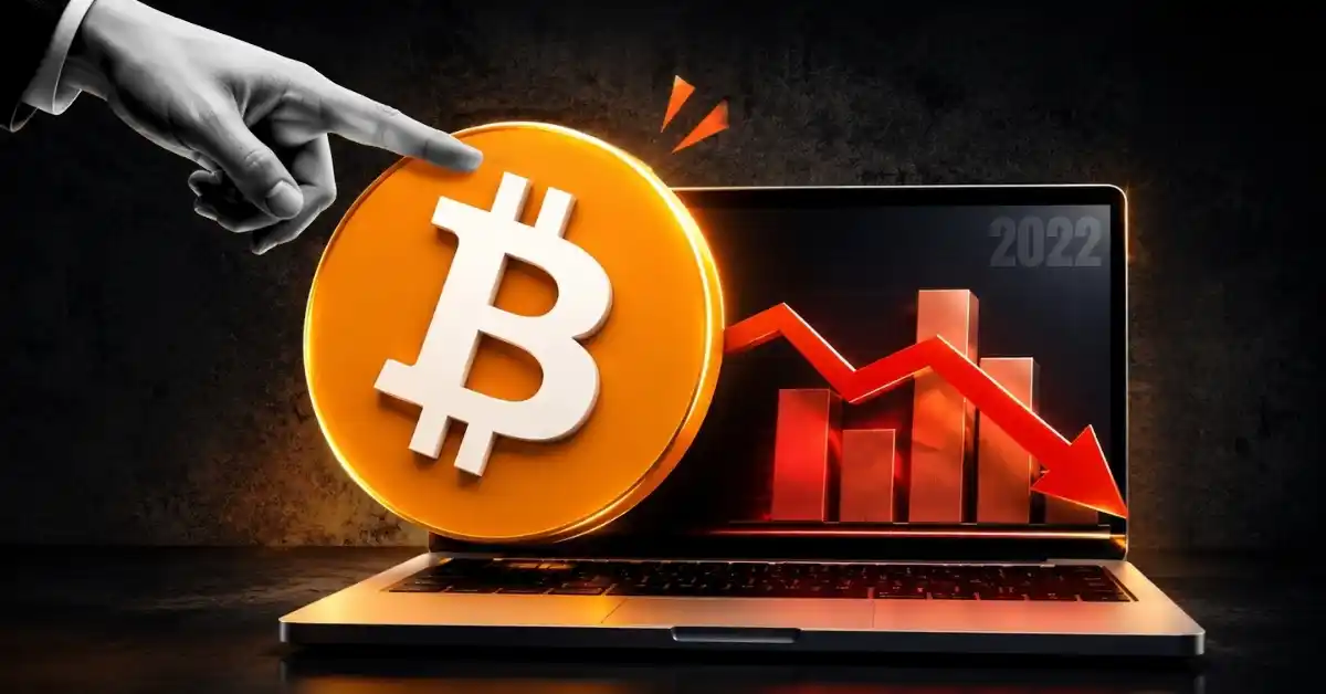 A gold Bitcoin token in front of a steep downward-trending red market graph.