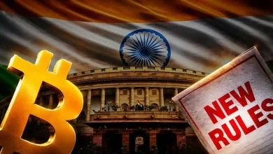 Golden Bitcoin sign and a "New Rules" document before the Indian parliament house.