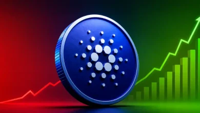 Large blue Cardano ADA coin in front of a red and green line graph chart.