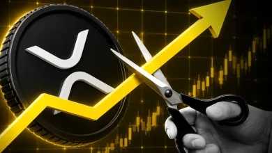 A hand cutting a rising yellow arrow with scissors next to a black XRP token coin.
