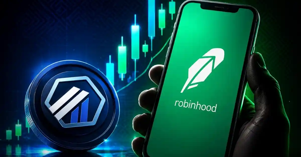 A hand holding a smartphone showing the Robinhood app next to an Arbitrum token.
