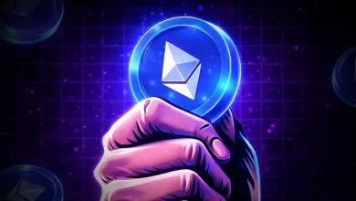 A hand firmly holding a glowing blue Ethereum token coin.