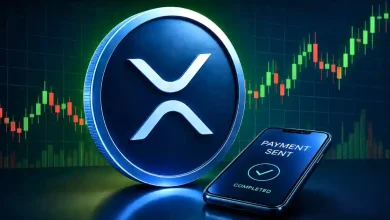 Blue XRP coin beside a smartphone showing a completed payment notification.