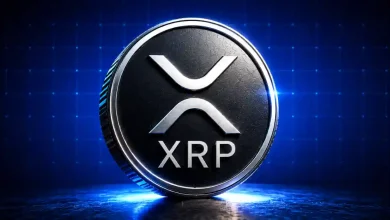Silver XRP coin glowing on a blue tech background.