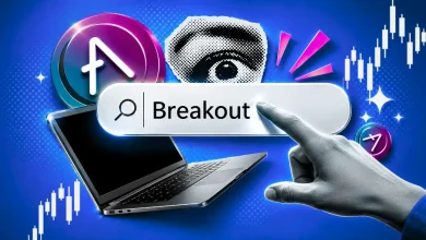 Hand searching breakout near Aave logo and laptop with rising chart.