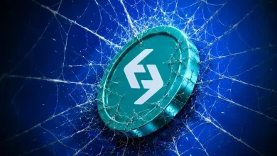 Teal Bitget token caught in a spiderweb against a blue background.