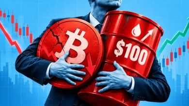 Person holding a cracked red Bitcoin coin and a $100 oil barrel with market charts