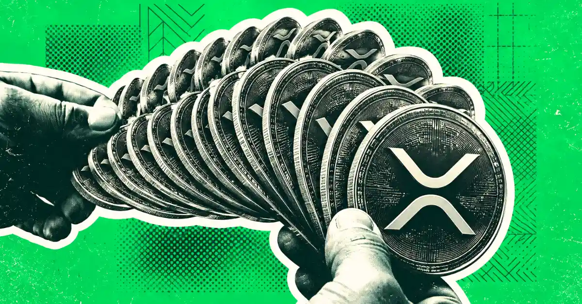 Hands fanning out a stack of silver XRP coins like playing cards