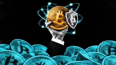 Hand holding a Bitcoin coin with a padlock shield surrounded by atomic quantum orbits