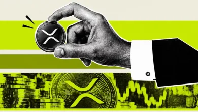 Hand holding XRP coin over stacked XRP cryptocurrency tokens and price chart
