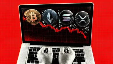 Cracked Bitcoin, Ethereum, Solana, and XRP coins on a laptop with a falling chart